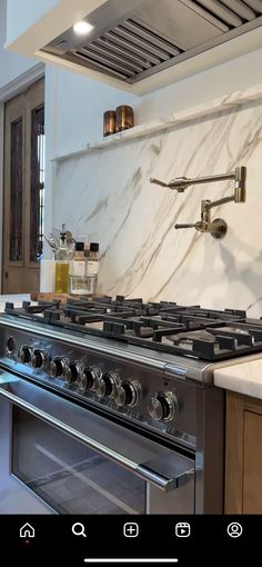 a stove top oven sitting inside of a kitchen next to a wall mounted range hood