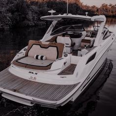 a boat is docked in the water with its seats folded out on it's side