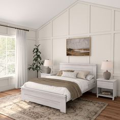 a white bed sitting next to a window in a bedroom