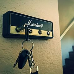 there is a keychain hanging on the wall next to a set of stairs