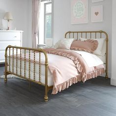 a bedroom with white walls and wooden floors