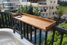 a wooden tray sitting on top of a balcony