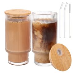 an image of a drink in a glass container with straws and drinking glasses next to it