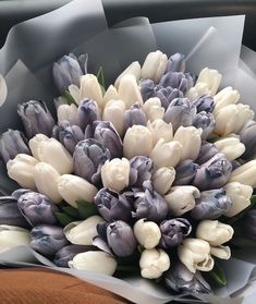 a bouquet of white and grey tulips