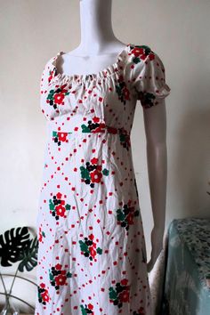 Amazing True Vintage 1970s maxi dress from Finnish designer Heikkilä. Comfortable cotton fabric with nostalgic floral print pattern on white background. Short sleeves, elasticated neckline and cuffs. Fit & flare cut, empire waist. Sewn on tie belt. Zipper in the back, unlined. Made in Finland! BRAND: Heikkilä ERA: 1970s COLOR: White, red, dark blue, green Fabric: No fabric tag, it's cotton SIZE: Vintage size 38, runs smaller and fits best size XS-S, please check the measurements below for refere Square Neck Cotton Maxi Dress With Floral Print, Retro Cotton Maxi Dress, Vintage White Floral Print Maxi Dress, Retro Floral Print Maxi Dress For Daywear, Vintage White Maxi Dress With Floral Print, Blue Green Fabric, Floral Prints Pattern, Red Dark, Maxi Dress Cotton