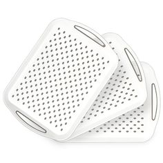 three white serving trays with holes on them