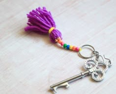 a keychain with a tassel hanging from it's side on a table