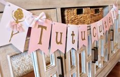 a pink and gold banner with the word tutu on it