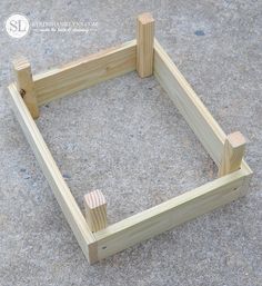 an unfinished wooden frame sitting on the ground