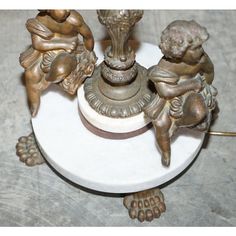 three figurines sitting on top of a white table