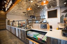 the inside of a restaurant with food and drinks on display in front of an open counter