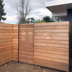 a wooden fence that is next to a building