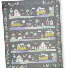 a quilt with cars and houses on it