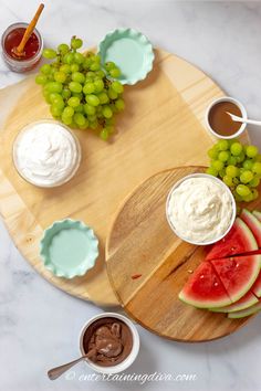 watermelon, grapes and whipped cream on a wooden platter