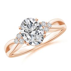 a rose gold engagement ring with an oval cut diamond and two round diamonds on the side