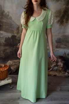 Everyone will be green with envy when they see you in this lovely retro vintage 60s maxi dress! It is perfect for any Jane Austen fan with its Regency era silhouette. The color is a beautiful green sorbet. Darling eyelet lace is featured on the puff sleeves. It has an empire waist, with a zipper in the back and ties. It is in pristine condition.  Brand: Union Made  No noticeable flaws Size: Approximately modern Small Measurements taken lying flat:  19" underarm to underarm  16" empire waist 10" sleeve length  6" arm opening 54.5" length *All vintage items are FINAL SALE. Please email with any questions before purchasing. We are happy to help with any inquires! *Please note that though we look over each vintage and antique item extensively and note flaws in descriptions, these are still age Green Retro Vintage Dress, Vintage Puff Sleeve Dress For Spring, Spring Vintage Dress With Puff Sleeves, Retro Vintage Dress For Spring Events, Retro Vintage Dress With Peter Pan Collar, 1950s Style Green Vintage Dress For Spring, Retro Puff Sleeve Dress For Vintage Fashion, Retro Vintage Fashion Dress With Puff Sleeves, Green Retro Vintage Dress With Short Sleeves