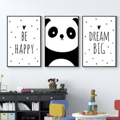 two panda bears are hanging on the wall next to a black and white table with chairs