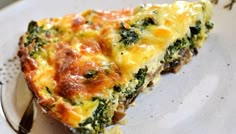 a slice of quiche with cheese and spinach