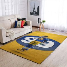 a living room with a white couch and yellow rug