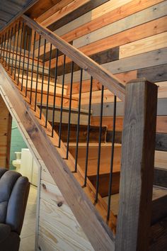 a wooden stair case with metal handrails