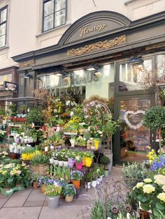 a flower shop with lots of flowers in front of it