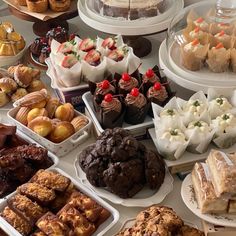 a table topped with lots of different types of cakes and pastries next to each other