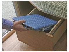 a person opening a drawer with a blue cloth in it and another hand reaching for something