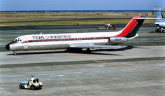 an airplane is parked on the tarmac with other planes in the back ground behind it