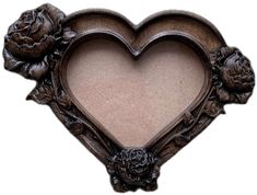 a wooden heart shaped frame with roses on the edges and an ornate border around it