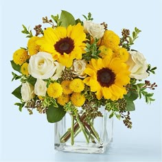 a vase filled with yellow and white flowers