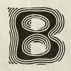 the letter b is made up of black and white circles on a piece of paper