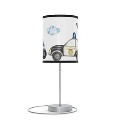 a lamp with a police car design on it and a black shade over the top