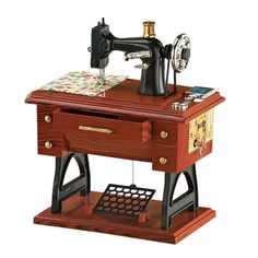 an old fashioned sewing machine sitting on top of a wooden table