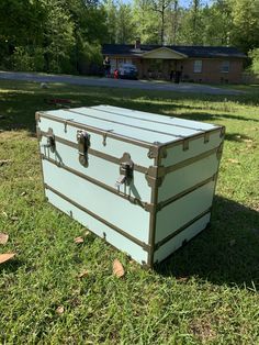 an old trunk is sitting in the grass