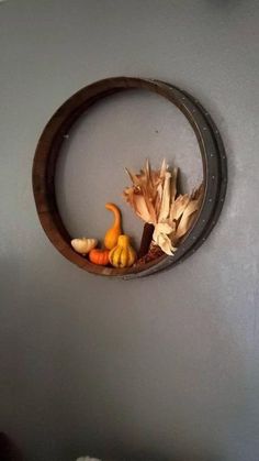 a wall hanging on the side of a room with pumpkins and gourds