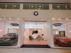 a car showroom with two cars in it