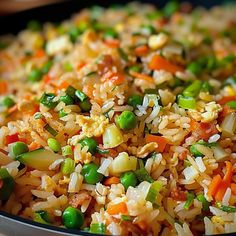 rice and vegetables are mixed together in a pan