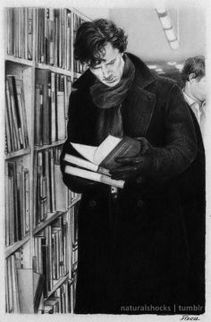 two men looking at books in a library