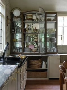 a kitchen filled with lots of clutter and dishes