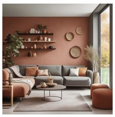 a living room with an orange wall and grey couches, coffee table and shelves on the wall