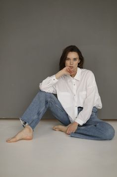 a woman sitting on the floor with her legs crossed