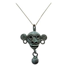 Unveil the elegance of antiquity with this fantastic copper bell pendant cast as the head of a monkey with applied wire facial features from Latin American, Mexico, Mixtec culture, Post-Conquest period, circa mid-16th century. The finely crafted ancient artifact is a testament to the artistry of the Mixtec culture. Spherical bells dangle from the end of each chin and snout, while suspension loops on the top indicate it was intended to be worn on a cord or sewn to clothing. The jangling sound of Diamond Circle Pendant, America Latina, A Monkey, Antique Pendant, Circle Pendant Necklace, Gem Necklace, Enamel Necklaces, Bell Pendant, Circle Diamond