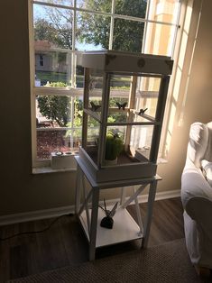 a living room with a window and a shelf