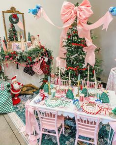 a decorated christmas tree in the corner of a room with pink and green decorations on it