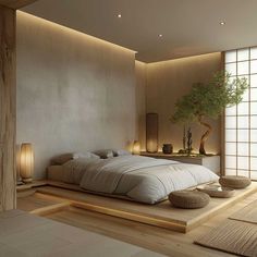 a large bed sitting in a bedroom next to a tall plant on top of a wooden floor