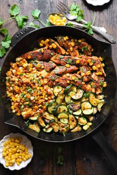 a skillet filled with vegetables and meat