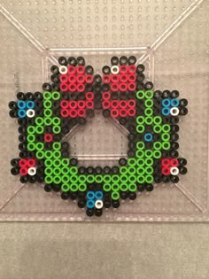 an image of a beaded object in the shape of a letter o on a wall