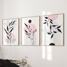 three paintings hanging on the wall above a bed in a white room with black and pink accents