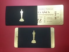 two black and white tickets with the oscar statue on them