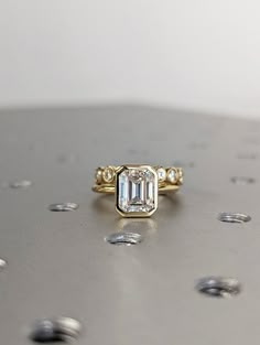 a diamond ring sitting on top of a table